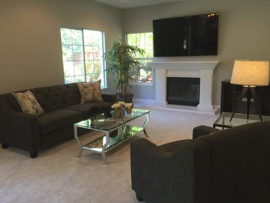 Grey sofa and love seat with chrome coffee table