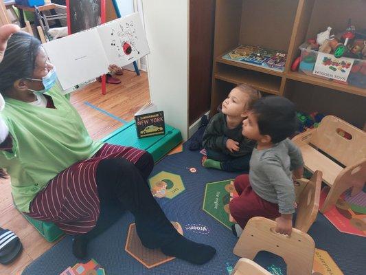 Intently listening during storytime while the others complete their nap.