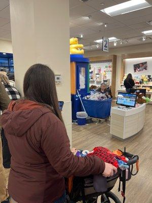 Lady stocking already full shoes instead of helping customers