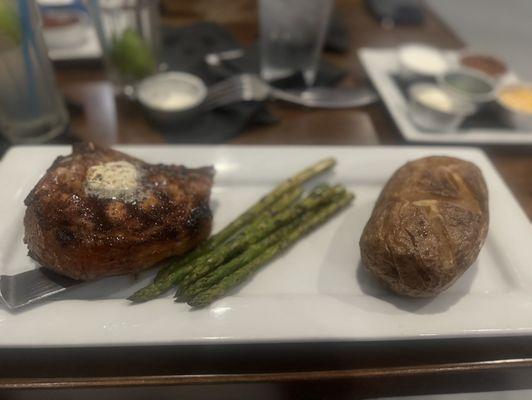 Porkchop meal with asparagus and baked potato