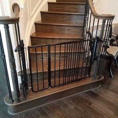 Black oversized gate for the bottom of a staircase