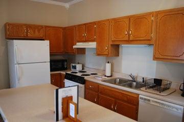 1st floor guest suite kitchen with sit-down bar and dining area.