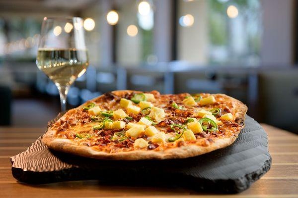 Our P,B,& J (pineapple bacon, jalapeno) pizza with a  nice glass of Tooth & Nail Sauvignon Blanc