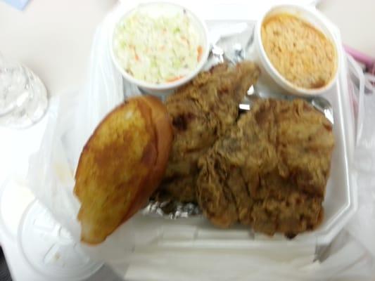 Fried pork chops, cole slaw, and rice and beans.