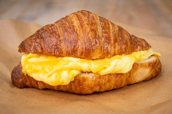 Toasted croissant sandwich, with fluffy scrambled eggs and sharp cheddar cheese