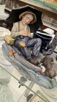 Guy sleeping in boat figurine.