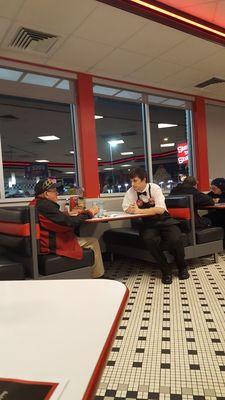 Amazing young man taking time out of his day to talk with a customer who was eating alone.