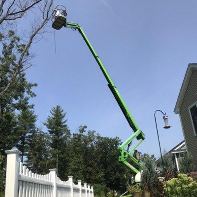 Tree removal using a lawn-friendly lift.