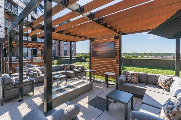 Outdoor sitting area with TV and fireplace.