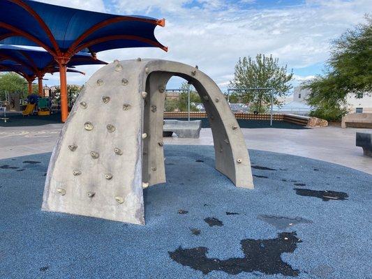 Small climbing feature near the play area.