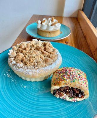 Apple pastry (apple pie filling under buttery crumb topping) + Italian cookie (candied orange/fig center)