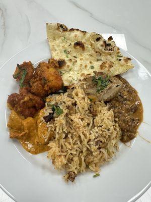 A plate of goodies with garlic naan