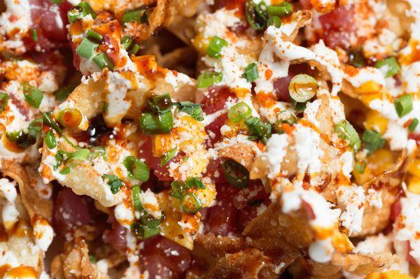 Wicked Tuna Nachos - Fried Wonton Chips topped with Tuna, Mango, Jalapeno, Sweet Soy Sauce, Lime Crema, Cilantro, Scallion & Togarashi