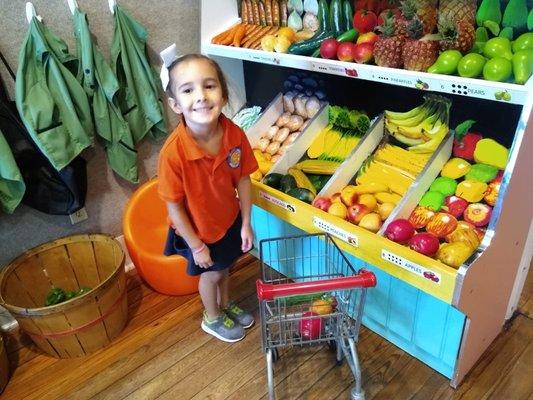 Learning about how a grocery store works, sorting fruits and vegetables, learning about math...