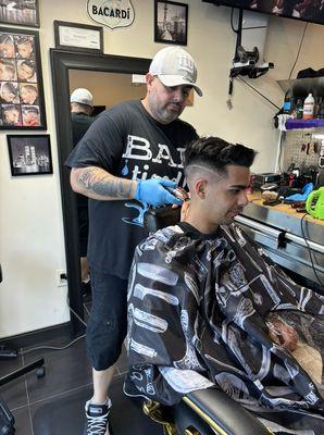 Our barber Jason, doing what he loves.