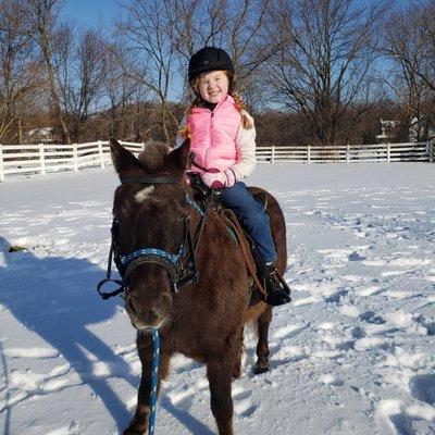 Sophia thrilled to ride out in the snow on Latte