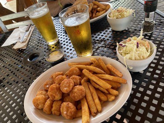 Hot delicious fried scallops with fries and cole slaw.