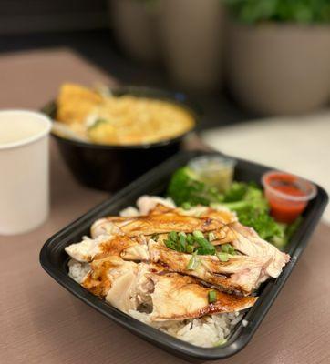 Hainan Chicken Rice: Poached lemongrass-ginger chicken w/ side soup, broccoli, sauces: ginger-scallion, umami, calamansi chili ($16.95)