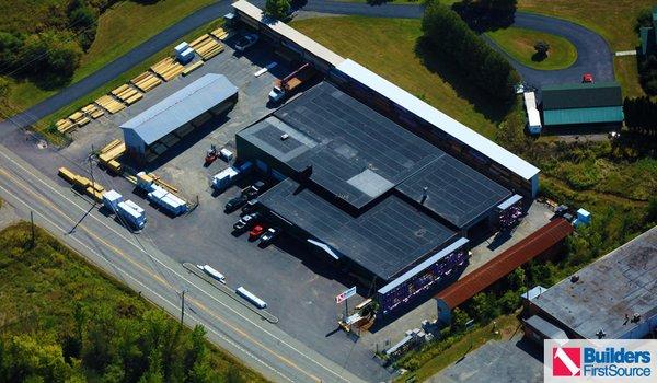 Building materials supplier Builders FirstSource's forklift is moving wood roof trusses.