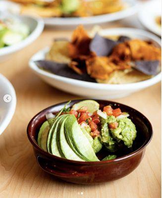 Guacamole with Rainbow Chips (blue corn, yellow tortilla, and sweet potato chips). Like everything we serve, our chips are homemade!