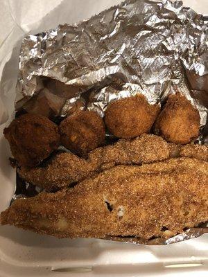 Fried catfish with 4 hush puppies.