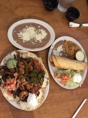 Fajita nachos (steak and shrimp), chicken chimichanga, and a side of beans.