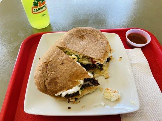 Steak torta, lime Jarrito, and hot sauce..