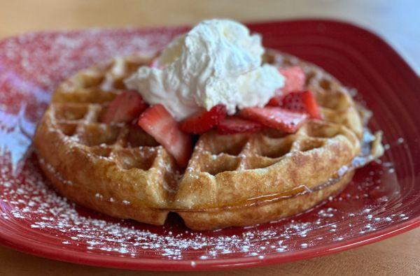 Sourdough waffle with fresh strawberries and whipped cream