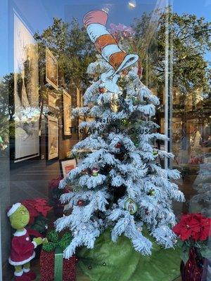 The grinch stuffed animal staring up at the Cat in the Hat tree topper. Fun!