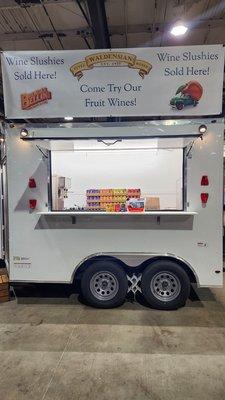 Wine serving trailer setup at an event in 2023.