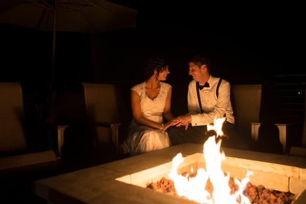 Newlyweds at fire pit on the patio. Photo credit: Ueda Photography