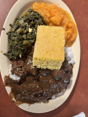 Beef tips, rice, greens, candy yams and cornbread.