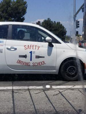 Is this school really teaching the proper education on driving? Seem like the person is texting while operating a motor vehicle.