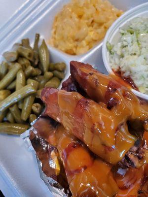 Our smoked wings, deep fried for a couple of seconds with our famous BBQ sauce. With our southern greenbeans, cheesy Mac creamy coleslaw