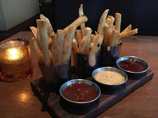 Complimentary seasoned fries with respective dipping sauces