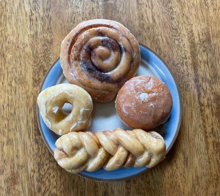 Cinnamon Swirl, White Cream Filled, Cinnamon Twist and Glazed Donut