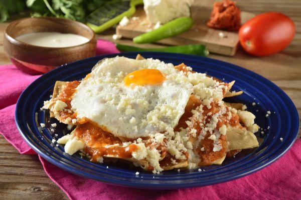 Red or Green Chilaquiles with eggs, sour cream and cheese on top.  Delicious.