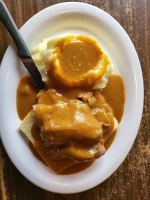 Hot open faced roast beef sandwich.