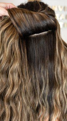 Invisible weft hair extensions.