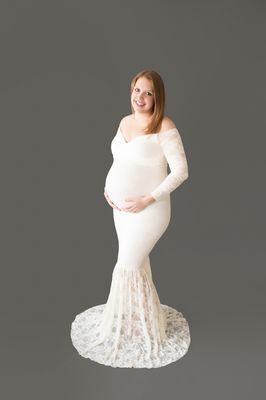 Beautiful pregnant Christina wearing cream lace maternity gown posed showing off perfect baby bump Gainesville FL