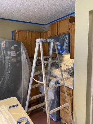 preparing cabinets to sand and paint in dark brown