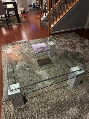 Glass top coffee table.  47x47 glass top.  Carrara marble Legs.  Excellent condition.