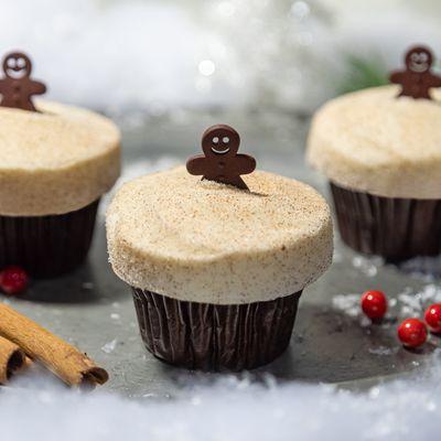 Spiced ginger cake topped with cream cheese frosting, dusted with cinnamon sugar and topped with a gingerbread man