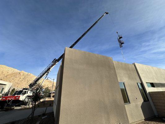 Spiral stair being craned over a house