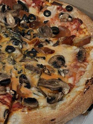 Plant based cheese, pepperoni, black olives and mushrooms.