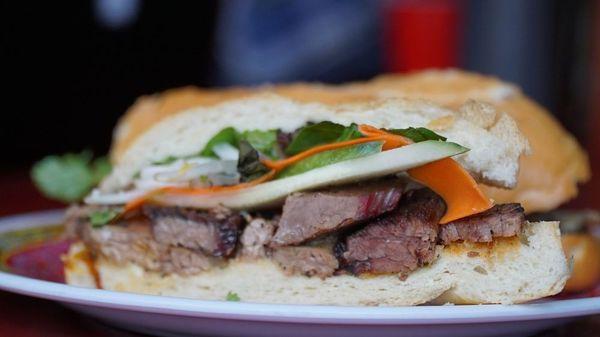 Our famous "Pho Banh Mi," made with 14-hour smoked brisket, bean sprouts, Thai basil, Hoisin sauce, Sriracha, lime, cucumbers, & more