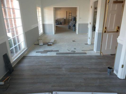 Vinyl plank flooring being installed in a hotel.