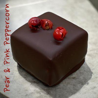 Pear & Pink Peppercorn truffle featuring a milk chocolate ganache infused with pear and pink peppercorns.