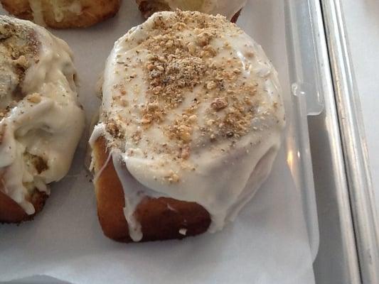 Cinnamon Roll with Walnuts and Vanilla Glaze sprinkled with crushed Walnut