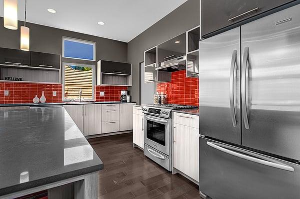 Lush glass subway tile backsplash in tomato red.